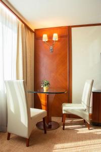 a dining room with a table and two chairs at Grandview Hotel Macau in Macau