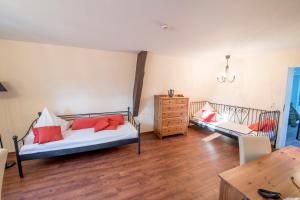 a bedroom with two beds and a wooden floor at Leipziger Hof in Fulda