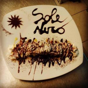 a white plate topped with a piece of cake at Locanda del Sole Nero in San Terenzo