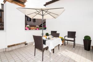 a table with a white umbrella on a patio at Cà Boldo Terrace 2.0 in Venice