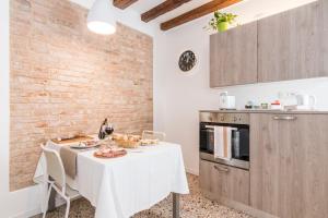 a kitchen with a table with a white table cloth at Cà Boldo Terrace 2.0 in Venice