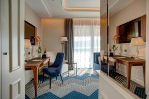 a hotel room with a desk and a room at Boutique Hotel La Roche in Tivat