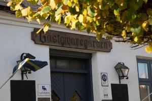 a sign on a building with a flag in front at Skanörs Gästgifvaregård in Skanör med Falsterbo