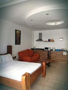 ein Wohnzimmer mit einem Bett und einem Sofa in der Unterkunft B12 Cowrie Beach Studio Apartment in Bamburi