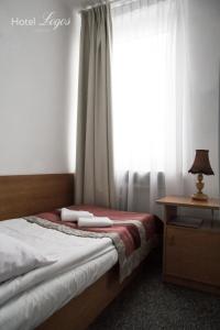 a bedroom with a bed and a window at Hotel Logos in Lublin