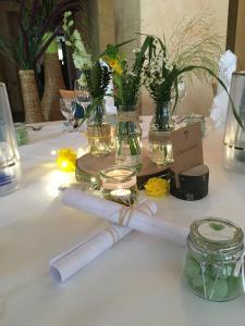 a table with flowers and candles on top of it at Kurhotel Fürstenhof by David in Blankenburg