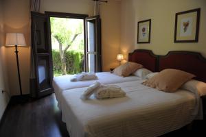 a bedroom with two beds with towels on them at Villa Turistica de Bubion in Bubión