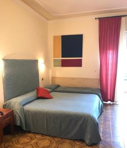 Vuode tai vuoteita majoituspaikassa Hotel Scala Greca