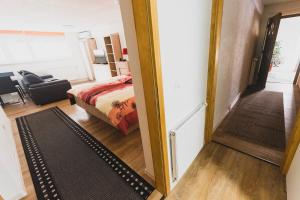 a room with a bed and a door leading to a bedroom at Apartment Berglez in Škofja Loka