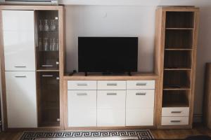 a entertainment center with a television in a living room at Apartment Berglez in Škofja Loka