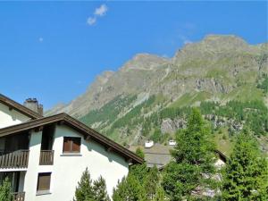 a building with a mountain in the background at Carla 12 in Sils Maria