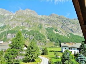 a view of a mountain with a house and a road at Carla 12 in Sils Maria