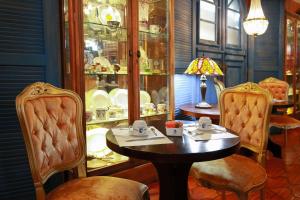 a dining room with a table and two chairs at Hotel Gramado Palace in Gramado