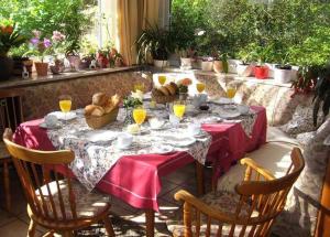 une table avec une nappe rouge et des chaises dans l'établissement Landhaus Eickhof, à Niederhaverbeck