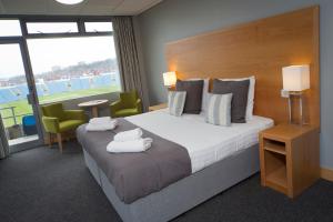 ein Hotelzimmer mit einem Bett mit Handtüchern darauf in der Unterkunft Headingley Lodge in Leeds