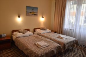 two beds in a hotel room with towels on them at Hotel *** NAT Kołobrzeg in Kołobrzeg