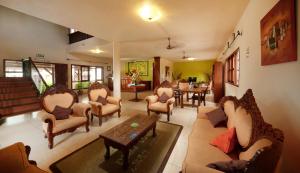 a living room with chairs and a table at Le Palmiste Resort & Spa in Trou aux Biches