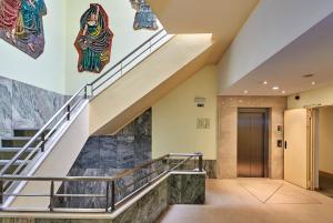 a staircase in a building with art on the walls at Luna Esperanca Centro Hotel in Setúbal