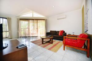 a living room with a couch and a table at BreakFree Aanuka Beach Resort in Coffs Harbour