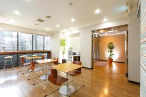 an office with two tables and chairs in a room at FLEXSTAY INN Ekoda in Tokyo