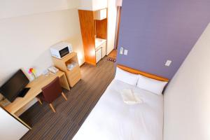 a hotel room with a large bed and a desk at FLEXSTAY INN Ekoda in Tokyo