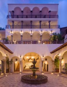 a courtyard with a fountain in front of a building at Casa Kimberly Boutique Hotel in Puerto Vallarta