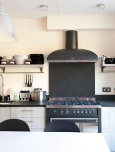 a kitchen with a stove top oven in a kitchen at Hotel Ladeuze in Leuven