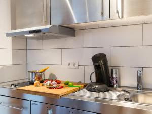 a kitchen with a cutting board with vegetables on it at Ruster Drachennest in Rust