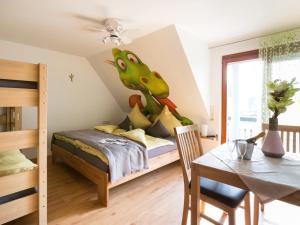 a bedroom with a dinosaur mural on the wall at Ruster Drachennest in Rust