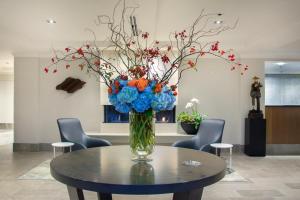 um vaso com flores azuis e laranjas numa mesa em Inn at the Market em Seattle