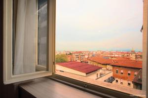 a window with a view of a city at Hotel La Pace in Pisa