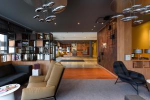 a living room with a couch and a chair at Mercure Hotel Mannheim am Rathaus in Mannheim