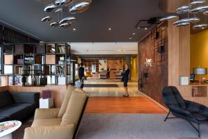 a woman is standing in a lobby at Mercure Hotel Mannheim am Rathaus in Mannheim