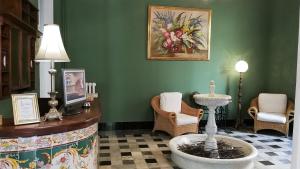 a room with a table and chairs and a sink at Hotel El Xalet in Sitges