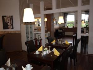 een eetkamer met tafels en stoelen in een restaurant bij Hotel am Schützenberg in Gotha