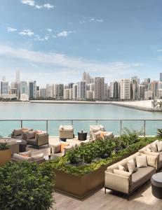 eine Terrasse mit Sofas und Stadtblick in der Unterkunft Four Seasons Hotel Abu Dhabi at Al Maryah Island in Abu Dhabi