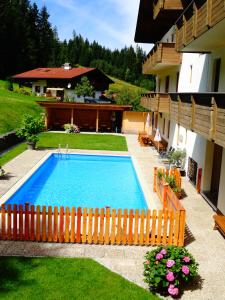 una piscina en un patio junto a una casa en Ferienhotel Iris, en Auffach