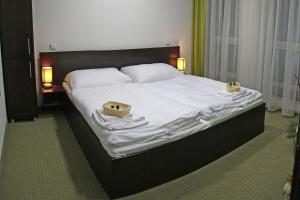 A bed or beds in a room at Penzion Luxury