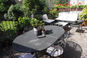 a black table and chairs on a patio at Teodora B&B in Milan