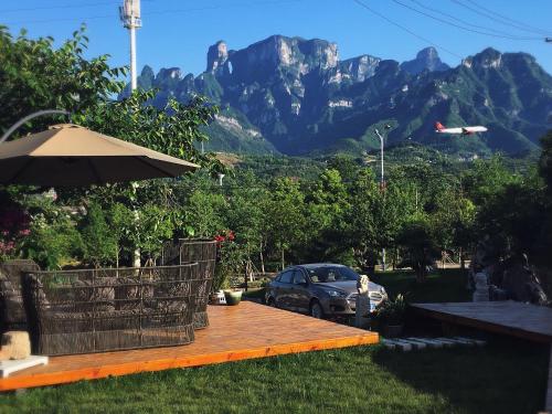 a car parked on a wooden deck with mountains in the background at Dao Bian Inn in Zhangjiajie