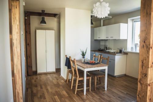 a kitchen and dining room with a table and chairs at Krauklis beach apartments in Saulkrasti