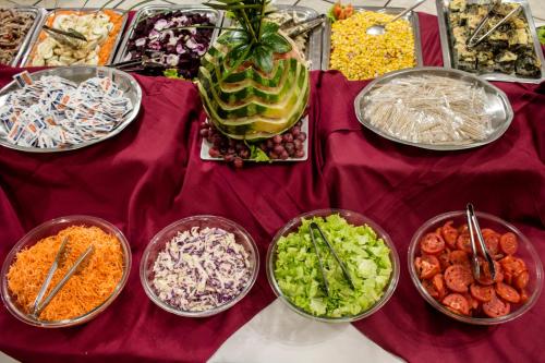 a table topped with bowls of different types of food at Hotel El Libertador in Puerto Iguazú