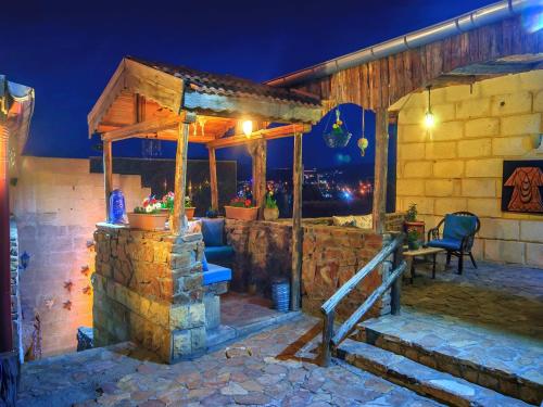 a stone house with a stone staircase leading to a patio at Adanos Konuk Evi in Avanos