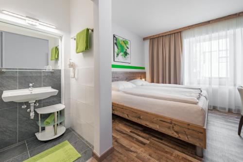 Tempat tidur dalam kamar di City Rooms Wels - contactless check-in