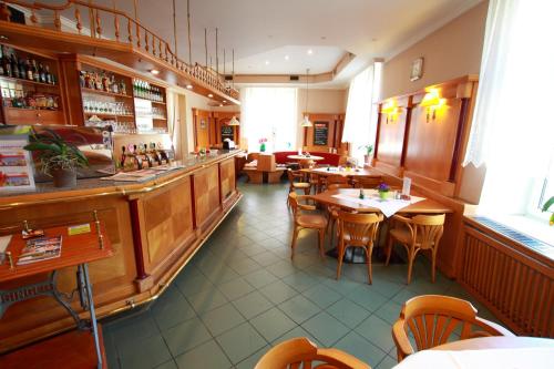 un restaurant avec des tables et des chaises ainsi qu'un bar dans l'établissement Hotel U Divadla, à Znojmo