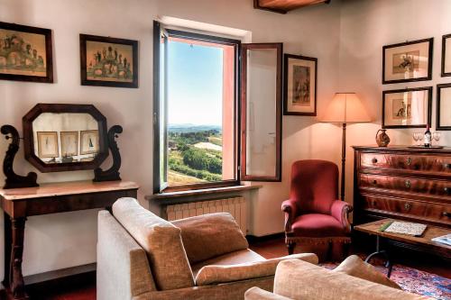 uma sala de estar com um sofá e uma janela em Hotel Santa Caterina em Siena