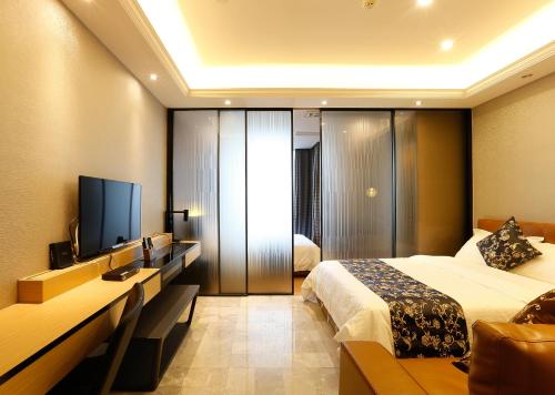 Giường trong phòng chung tại Boman Holiday Apartment Bei Jing lu Jie Deng Du Hui Branch