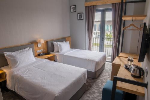 Postel nebo postele na pokoji v ubytování Redpine Boutique Hotel