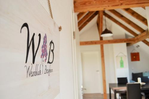 a wall sign in a dining room with a table at Weinblick in Besigheim