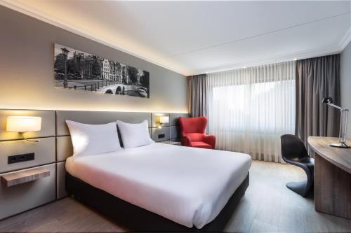 سرير أو أسرّة في غرفة في Ramada by Wyndham Amsterdam Airport Schiphol